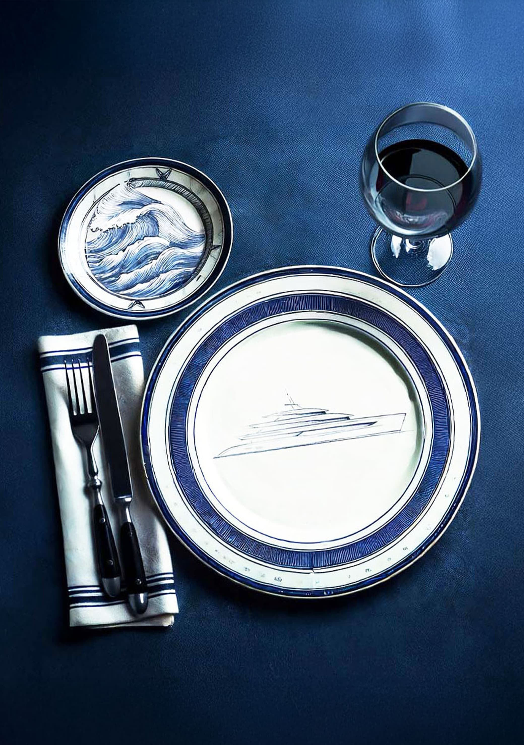 Armada Club branded yacht plates on a navy tablecloth